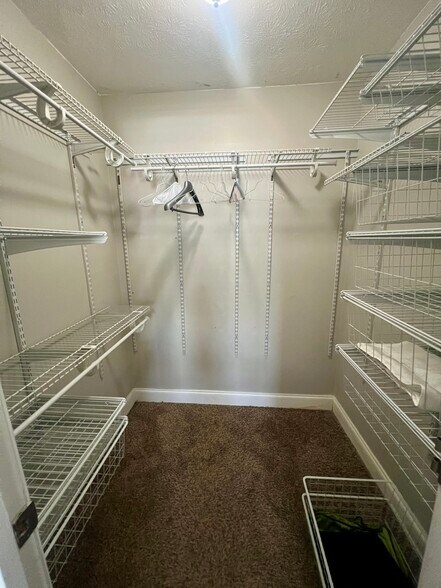 Primary bedroom's closet - 6980 Roswell Rd