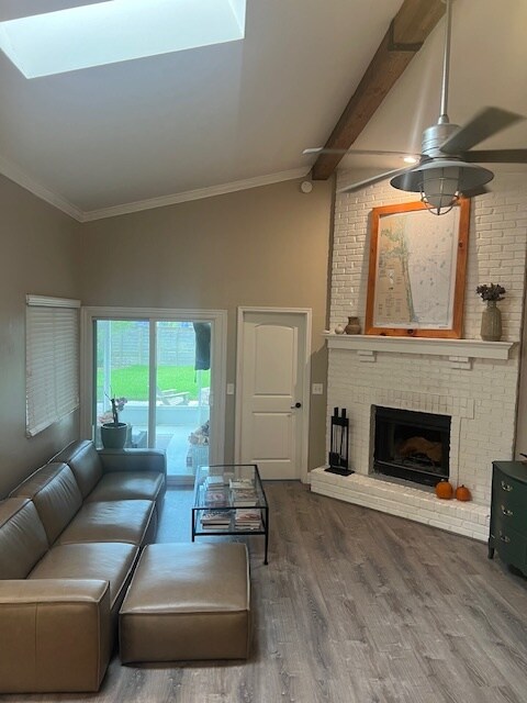 Spacious, open living room with fireplace focal point and patio access. - 953 13th Ave S