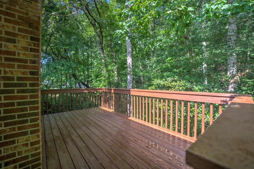 Large back deck surrounded by trees - 10 Southchase Dr