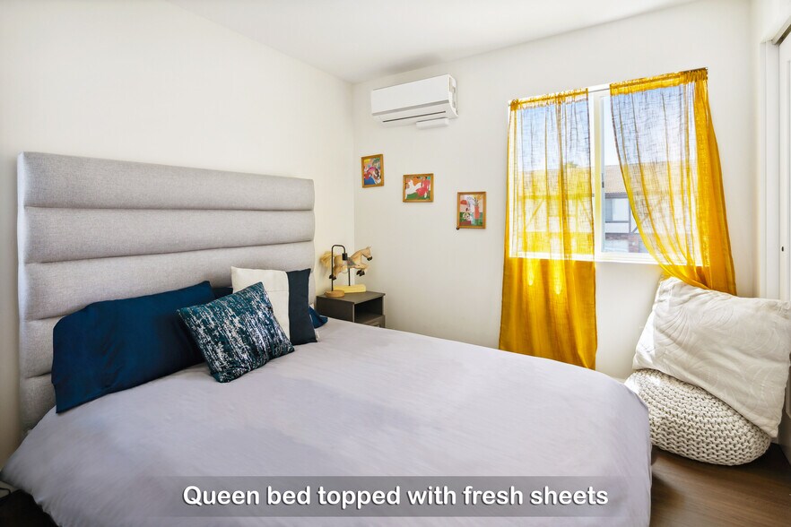 Recharge and get cozy in Bedroom 3 with a comfortable queen bed and a fluffy bean bag chair. - 721 E 22nd St