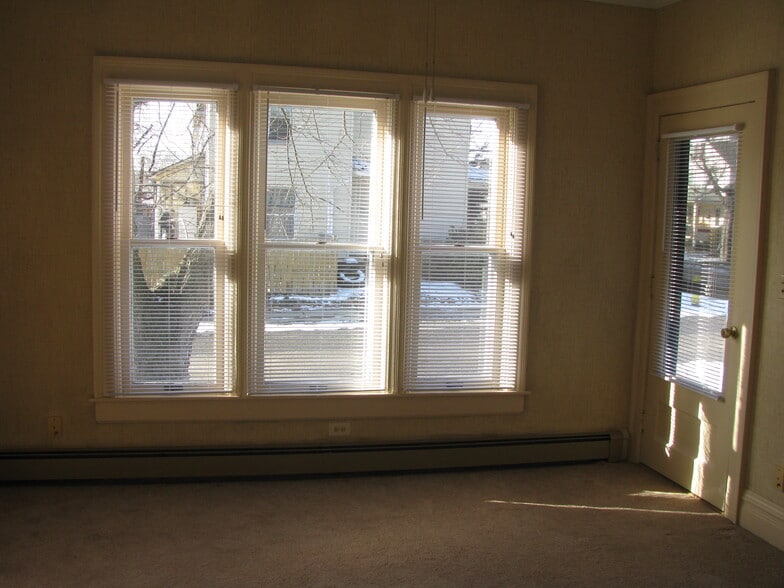 Living room with front door to right. - 100 Park Ave