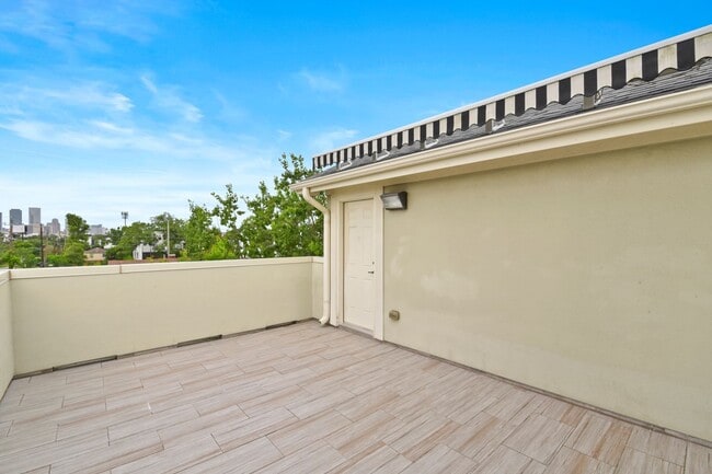 Building Photo - Light-Filled Corner Home with Rooftop Pati...