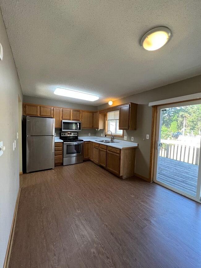 Building Photo - NE House for Rent 4 bedroom 2 full bathroom fenced in yard 2 Car attached garage.