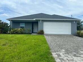 Building Photo - $500 off SPECIAL * Cape Coral 3BR/2BA Home with 2-Car Garage and Screened Lanai