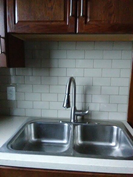 newly renovated kitchen with new cupboards, tile and stainless steel appliances - 3210 Main St