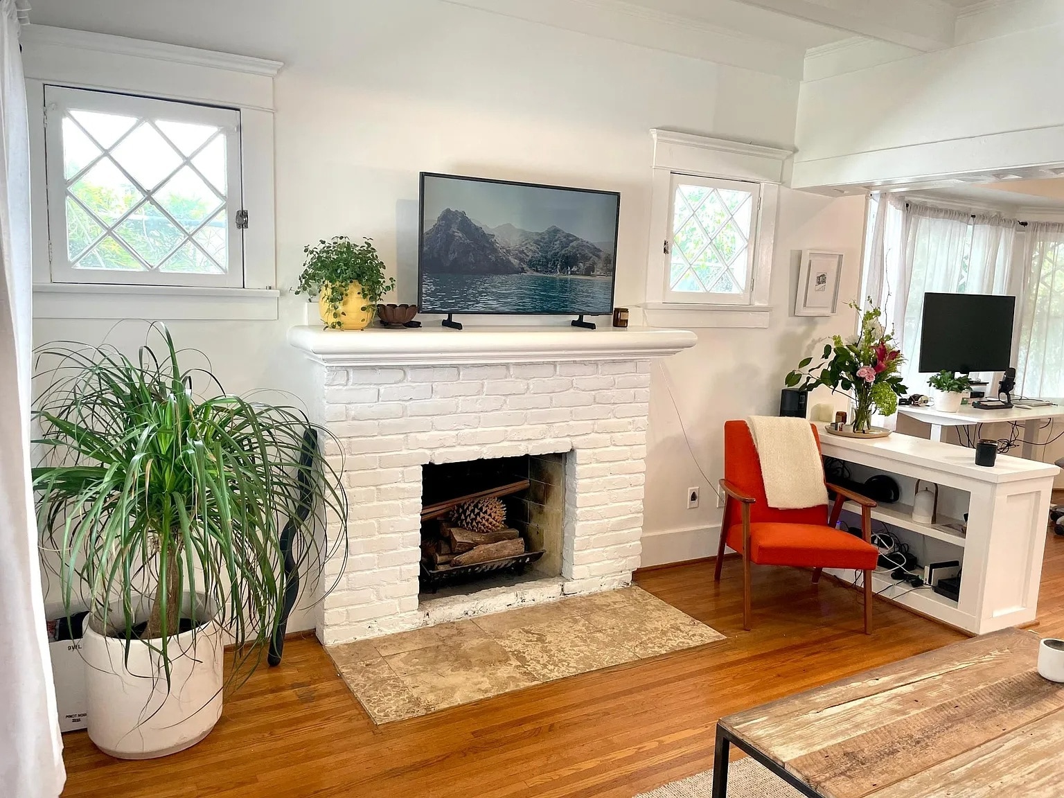 Open living area with built-ins and plenty of natural light, combining vintage charm with modern com - 6000 Carlton Way