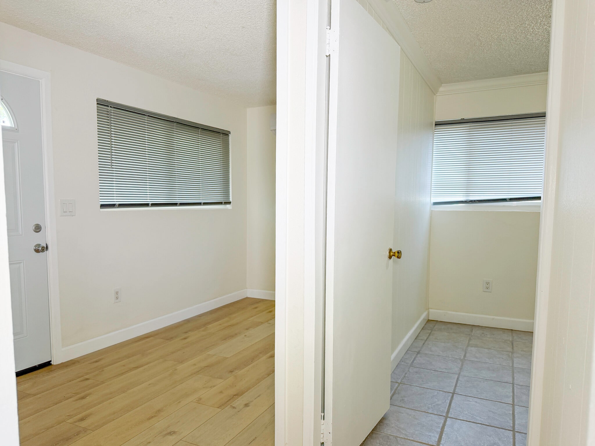 (B) Front entry room on left, bedroom on right, standing in door to kitchen - 1722 E Victoria Ave