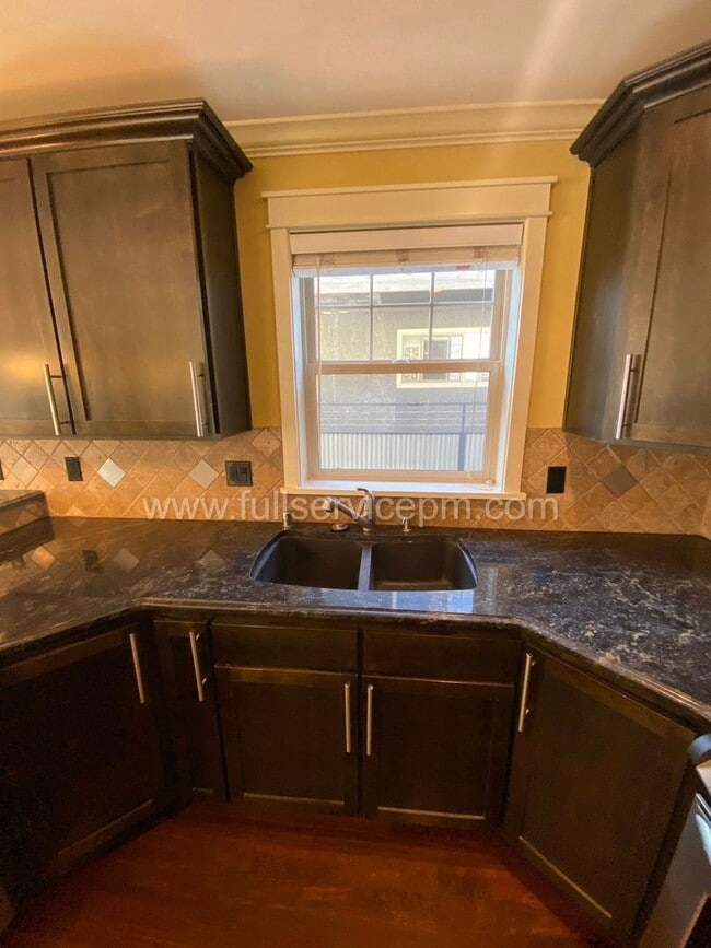 Building Photo - Spacious townhome with private backyard, garage parking, multiple decks, and a dedicated home off...