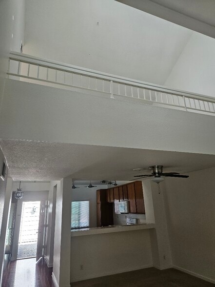 from living room looking up to the loft - 7532 Seaspring Dr