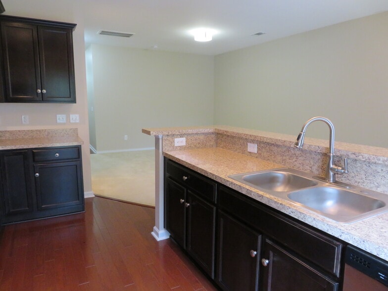 Kitchen at breakfast bar, w espresso cabinets, double sink w pull-down faucet,overlooking Great Room - 2496 Stadium Dr