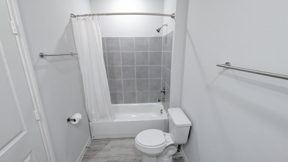 Fully tiled shower/tub combo completes this primary bathroom. - 13218 HP Johnson St