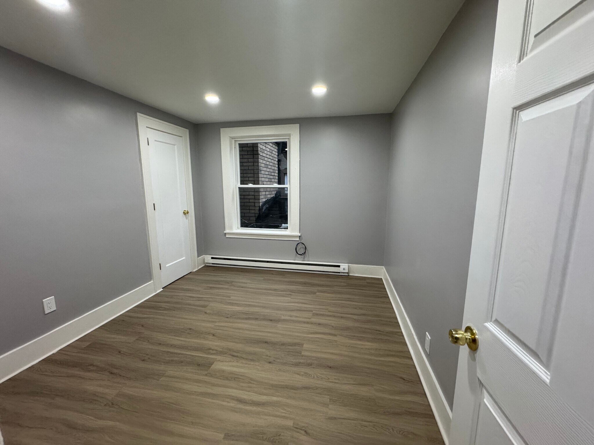Bedroom 2 (Rear-Facing Window)- Secondary bedroom with ample closet space and bright window. - 898-902 Portland Ave