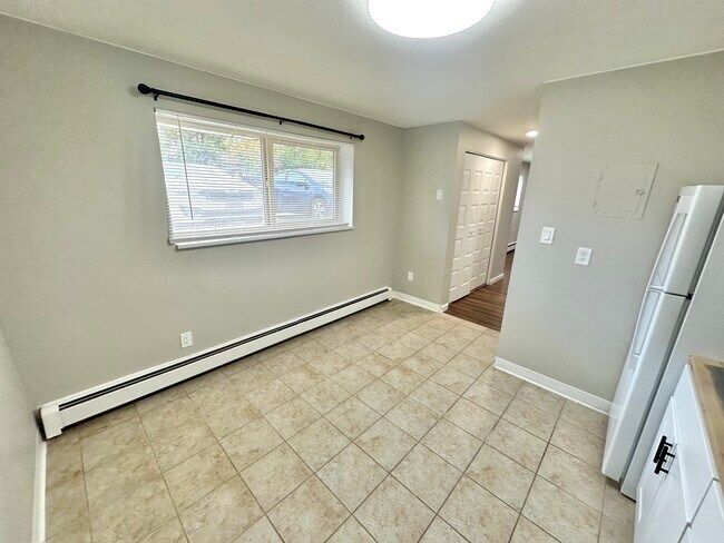 Enjoy natural light and comfort in this cozy kitchen space. - Country Club