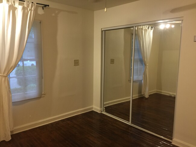 Mirrored sliding closet doors in bedroom. - 787 Forrest St NW