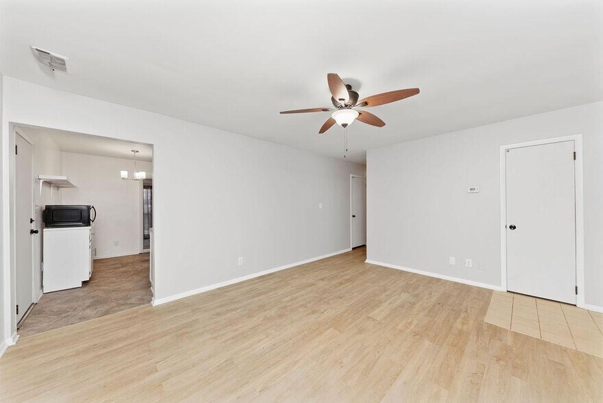 Light and bright living room with ceiling fan, solid surface flooring - 11 Lawndale Ave