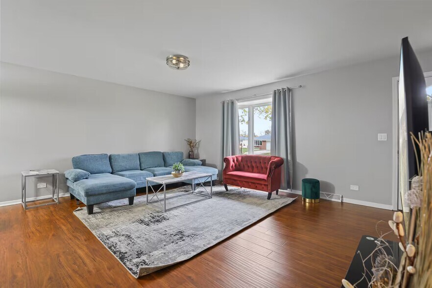 Living room with sleeper couch, smart TV and closet space. - 1002 Juniper Ln