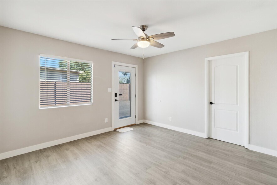 Large living room with all fresh paint, ceiling fans, doors, hardware and more! - 327 N 16th Ave