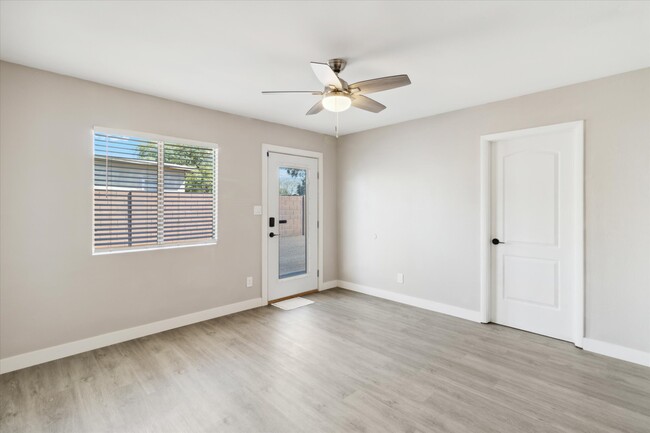 Large living room with all fresh paint, ceiling fans, doors, hardware and more! - 327 N 16th Ave