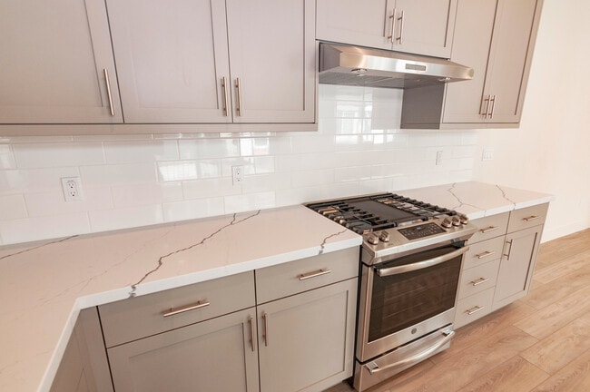 Building Photo - Experience contemporary urban living at its finest. Private Garage & Dual Suites!