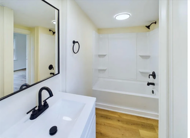 Bathroom: Full bathtub and built-in shelving, perfect for toiletries - 1011 Elm St