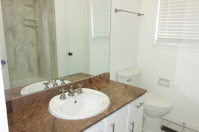 Upstairs full bath with granite tops and shower/tub combo and linen storage - 3421 E 35th St