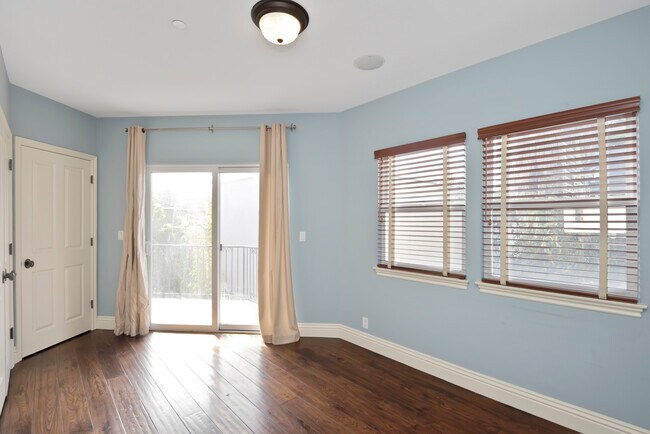 Bedroom #3 with sliding doors open to a deck - 620 13th St