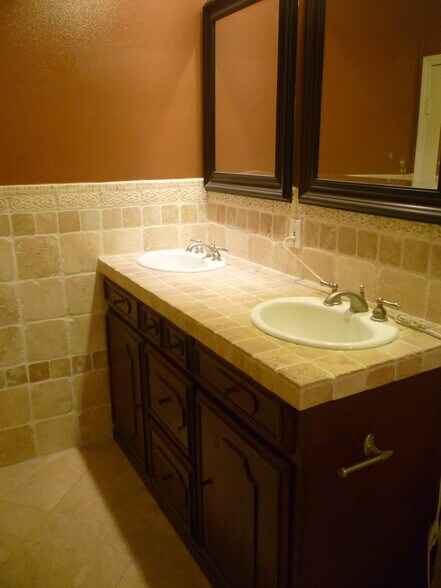 travertine tiled bathroom with double sinks - 937 12th St