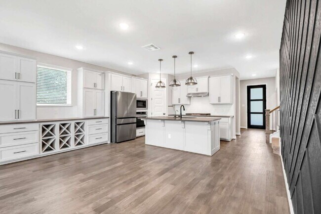 Building Photo - ASK ABOUT FREE APPLICATIONS THROUGH AUGUST!  "Spacious 4-Bedroom Sanctuary with Cozy Fireplace in...