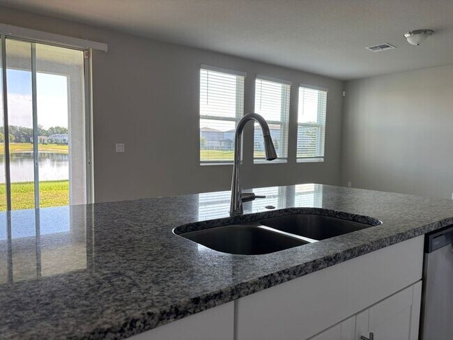 Building Photo - Like-New 4 Bedroom 3 Bath with Pond View & Two Living Spaces — Minutes to South Lake Nona
