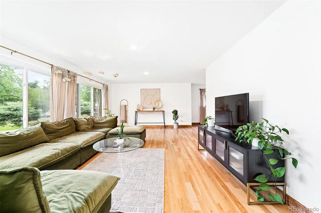 Bright, airy living room with new windows to provide peace and quiet home. - 516 Monaco Pky