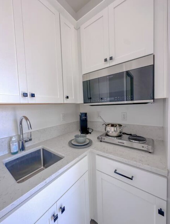 kitchenette with electric stove and microwave - 1964 N Mitchell St