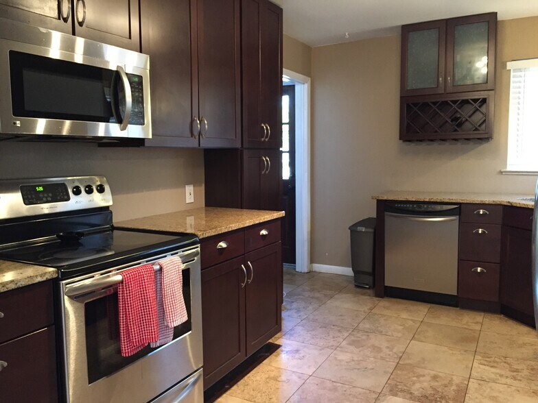 Stainless steel kitchen with tile floors and granite countertops - 4660 Perry St