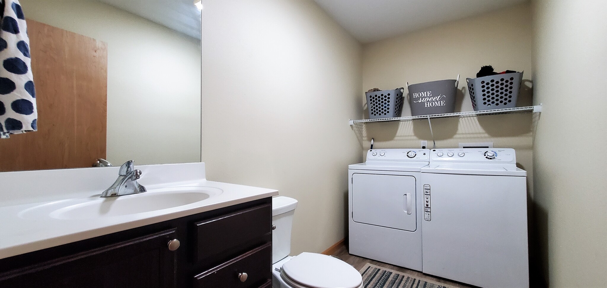 Main floor half-bath with laundry facilities. (photo from neighboring unit with the same layout) - 1756 St Joseph St