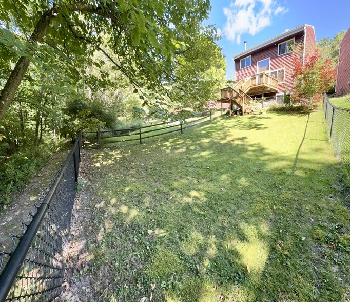 Fenced in backyard with gate to walking path to the woods - 113 Penny Ln