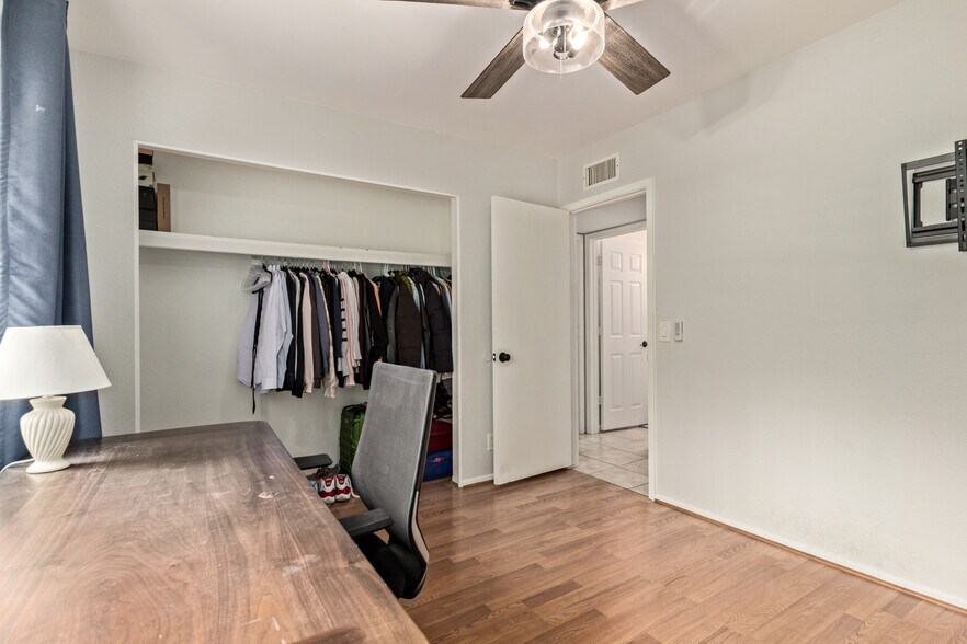 Secondary bedroom with closet and door - 115 W 10th St