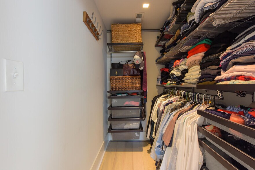 Primary walk-in closet with custom Elfa shelving. - 1001 Monroe St NW