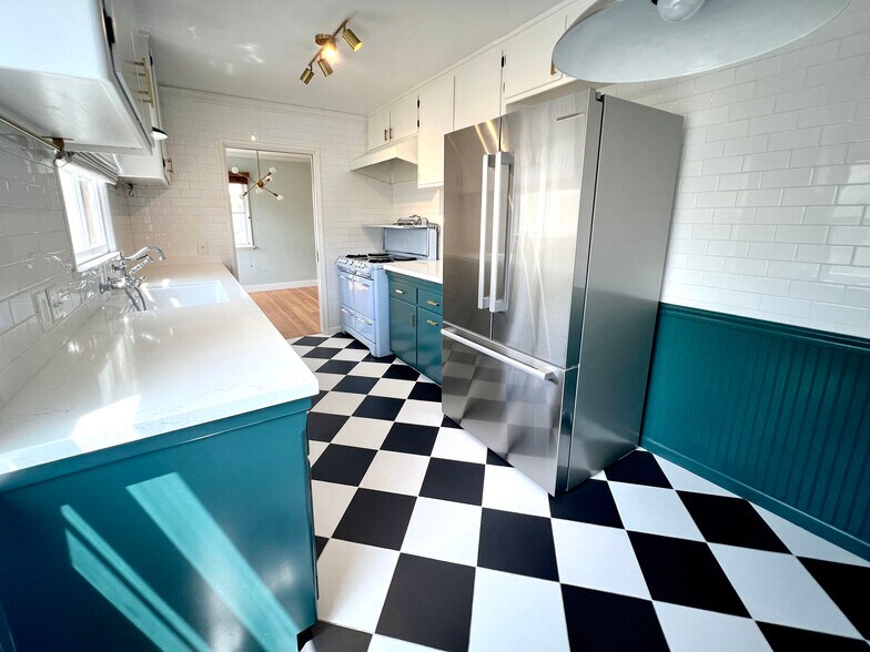 Kitchen with stainless steel refrigerator, refurbished vintage O'keefe and Merritt stove. - 1327 N Central Ave