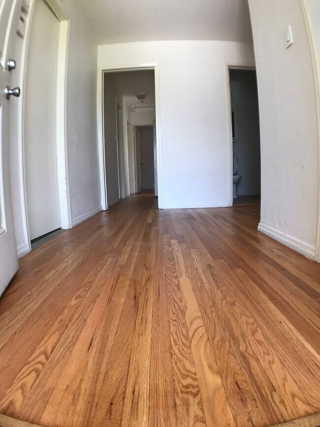 Building Photo - BEAUTIFUL WOOD FLOORS IN THIS 5 BED 2 BATHROOM HOUSE- LARGE DOGS OK