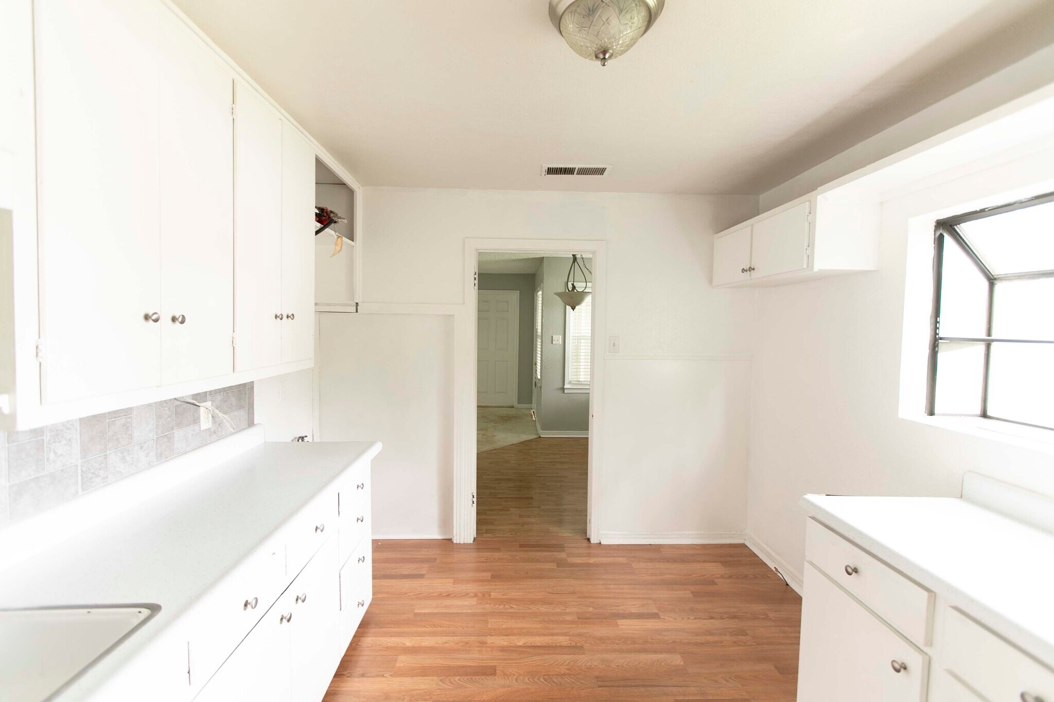 Kitchen looking into dining area. Stack-able washer/dryer goes to the left of the door. - 7459 Mohawk Ave