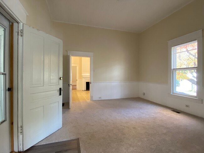 The office/study has an exterior door to small shared back porch with steps to back yard. - 218 Linden Ave