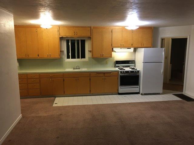 View from front door entrance to kitchnette + cabinetry. Gas oven/stovetop + refrigerator. - 60 Cold Springs Rd, Apt