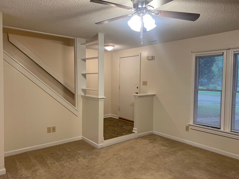 Living room facing front door and stairs - 411 Hobbs Rd SE