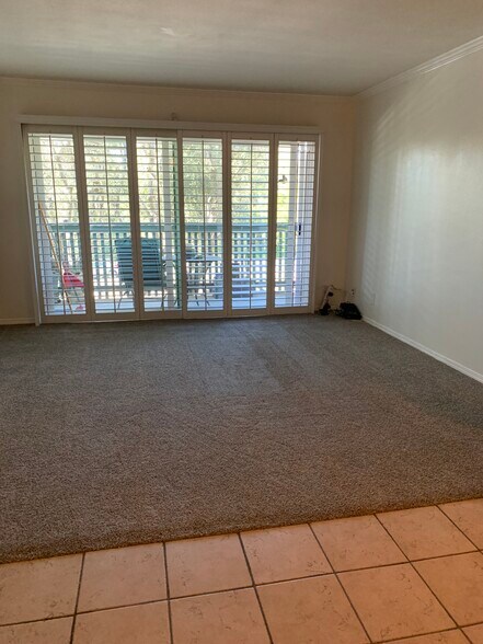 Living room with plantation shutters and new white vinyl double paned sliding glass doors - 436 N Bellflower Blvd