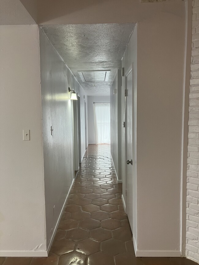 Great breezeway hallway with lots of natural light. - 13559 Red Fern Ln