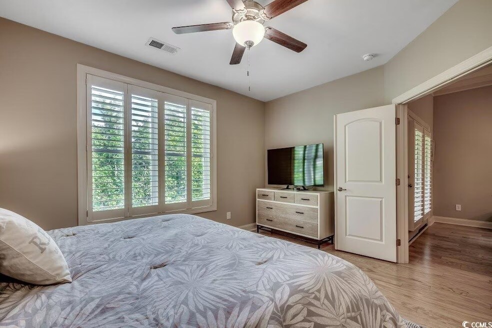 Primary bedroom on the back of the unit with a great view of the wooded area behind the development - 144 Puffin Dr