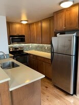 Kitchen with stainless steel appliances and quartz countertops - 5211 Fauntleroy Way SW
