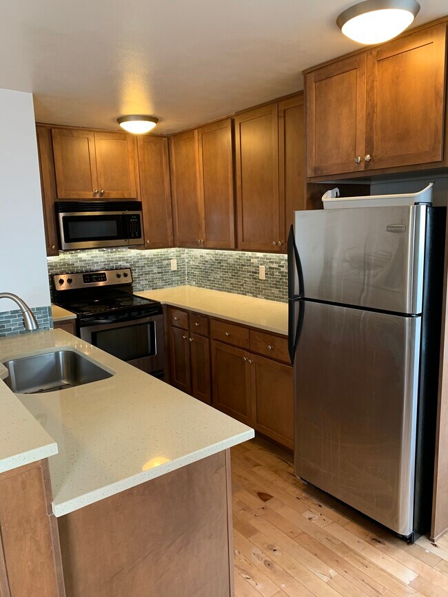 Kitchen with stainless steel appliances and quartz countertops - 5211 Fauntleroy Way SW