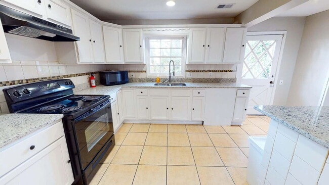 Building Photo - THE UNION GROVE | Gorgeous renovated home in Lithonia featuring large common areas, a spacious ki...