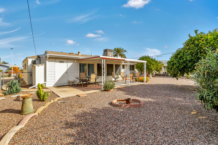 Large covered patio, gas grill, 2 patio table sets, abundant orange trees and a fully fenced yard. - 10113 W Pebble Beach Dr