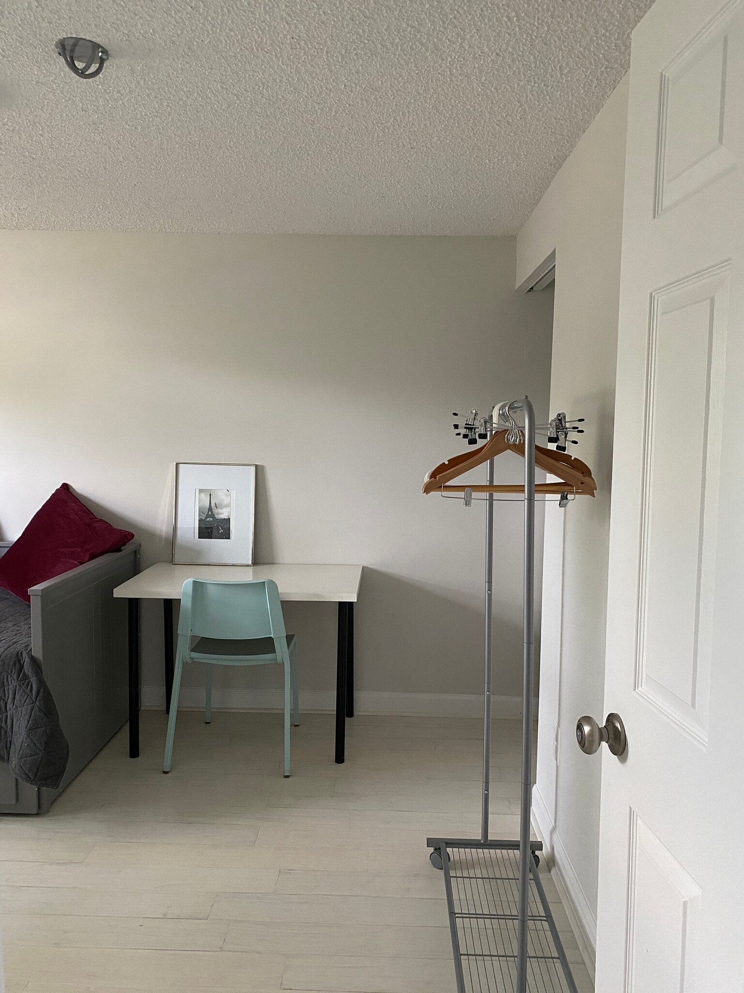 Desk area and view of the (movable) clothes rack. - 7922 Fitzroy St